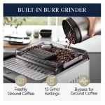 A glass being filled with cold brew coffee from the DeLonghi Eletta Explore, highlighting its cold extraction capability