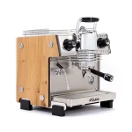 A sleek, Dalla Corte Mina Espresso Machine Wood, showcasing its distinctive manual lever (yoke) and modern design