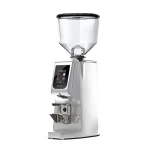 A sleek, Eureka Atom Excellence 65 Chrome espresso grinder on a countertop, highlighting its sturdy build