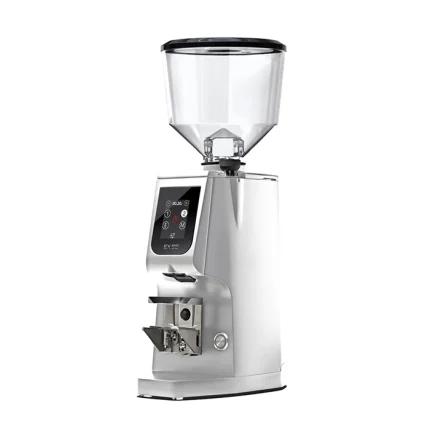 A sleek, Eureka Atom Excellence 65 Chrome espresso grinder on a countertop, highlighting its sturdy build