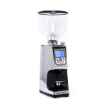 A sleek, Eureka Atom Specialty 65 Chrome espresso grinder on a kitchen counter, highlighting its compact design
