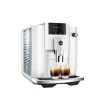 A sleek JURA E4 espresso machine white, showcasing its minimalist design on a kitchen counter