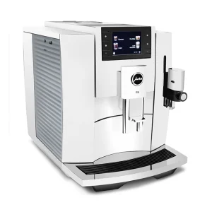 A sleek JURA E8 espresso machine white, displaying its full-color screen and coffee spout