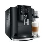 A sleek JURA S8 espresso machine black, displaying its large color touchscreen and a coffee cup ready for brewing