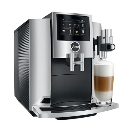 A sleek JURA S8 espresso machine chrome, displaying its large color touchscreen and a coffee cup ready for brewing