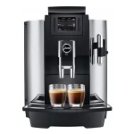 A sleek JURA WE8 coffee machine with its color LCD display illuminated, showcasing a prepared drink