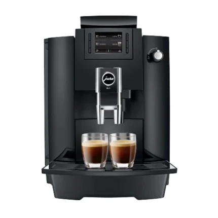 A sleek, black JURA WE6 coffee machine on a countertop, displaying its control panel