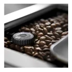 A view of the bean hopper and integrated conical burr grinder on the DeLonghi PrimaDonna Elite