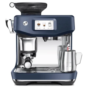 The automatic steam wand of the Breville Barista Touch Impress Blue perfectly frothing milk in a stainless steel pitcher