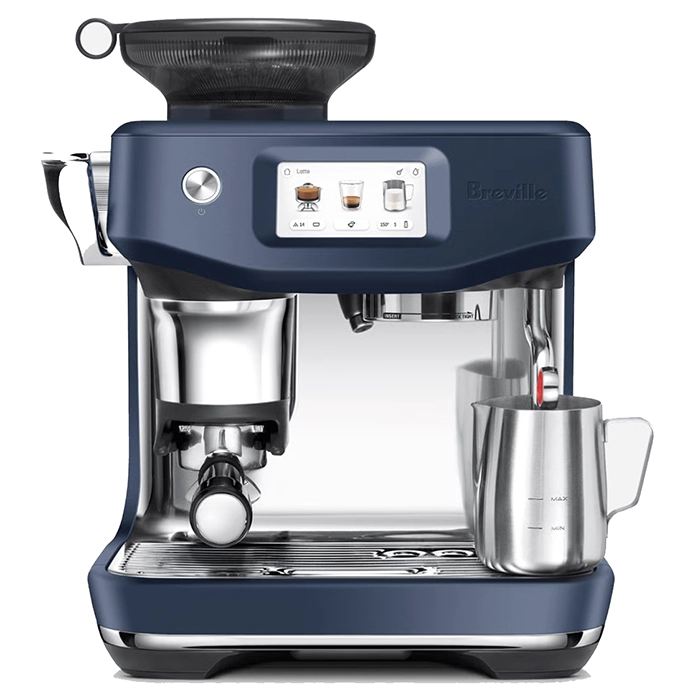 The automatic steam wand of the Breville Barista Touch Impress Blue perfectly frothing milk in a stainless steel pitcher